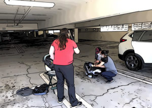 This picture shows a car seat event with cat seat checks being done hands-free due to a pandemic.